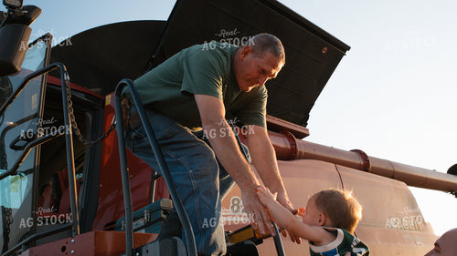 Farmer Helping Farm Kid into Combine 26055