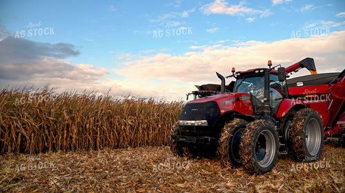Combine Unloading Corn into Auger Wagon on the Go 25643