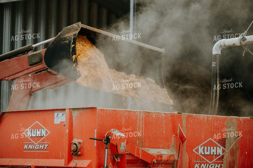 Tractor Emptying into feed mixer 77145