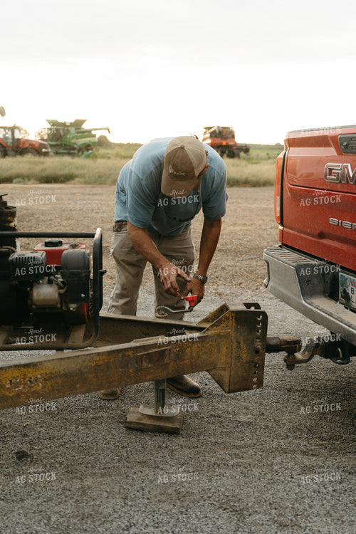 Farmer Hooking Up Trailer 125271