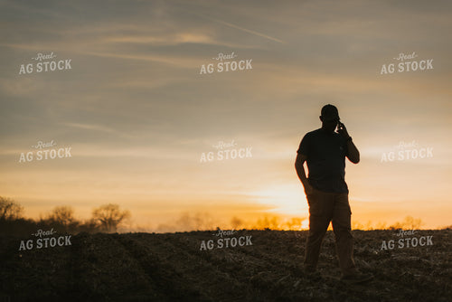 Farmer Talking on Phone in Field 7463