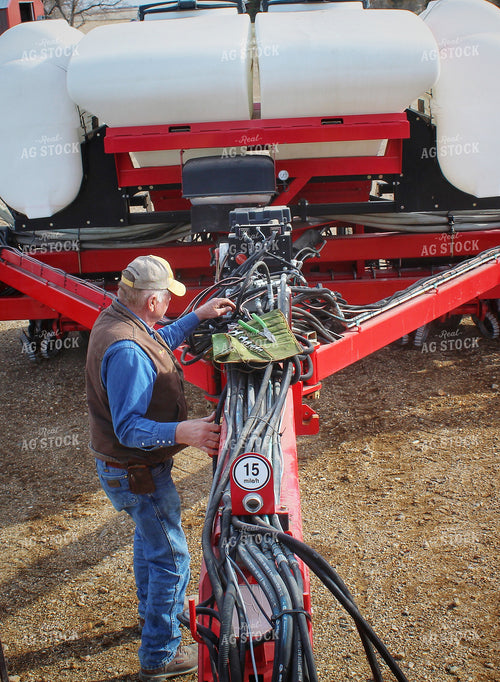 Farmer Fixing Planter 141207