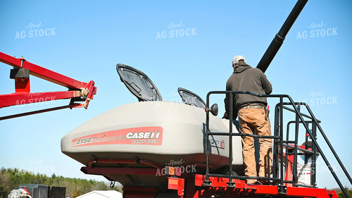 Farmer Loading the Planter with the Seed Tender 25097
