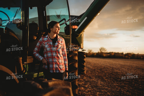 Female Farmer Climbing out of Tractor 3469