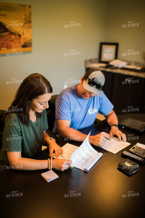 Husband and Wife Farmers Going Over Paperwork 6181