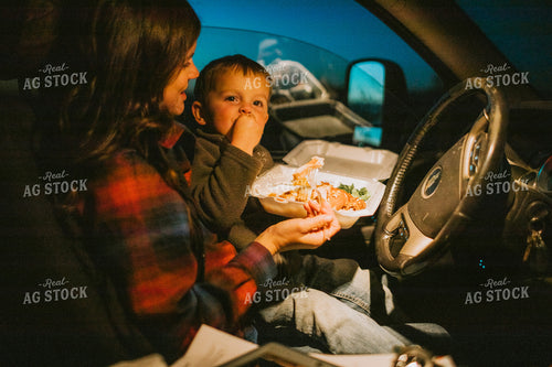 Farm Mom and Farm Kid Eating Field Meal in Truck at Night 5157