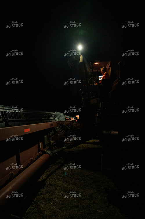 Combine Unloading Corn into an Auger Wagon at Night 25806