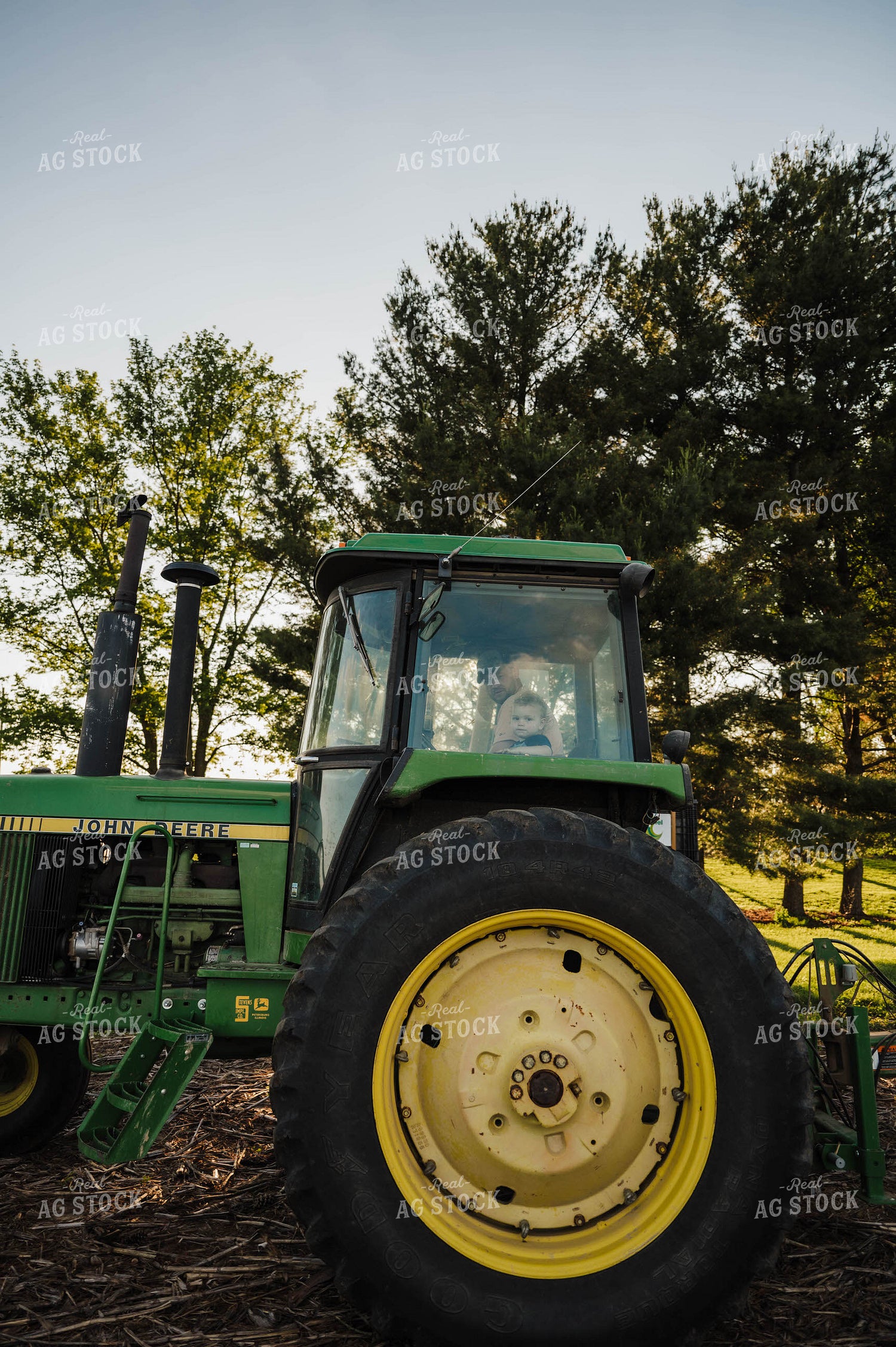 Farmer and Kid in Tractor 115205