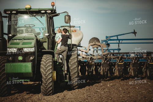Farmer and Daughter Climbing into Tractor with Planter 4194