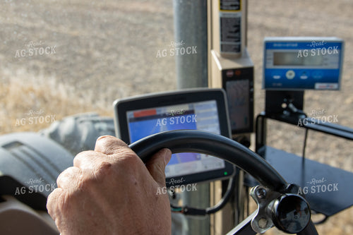 Farmer Hand on Steering Wheel with Planting Monitor 52082