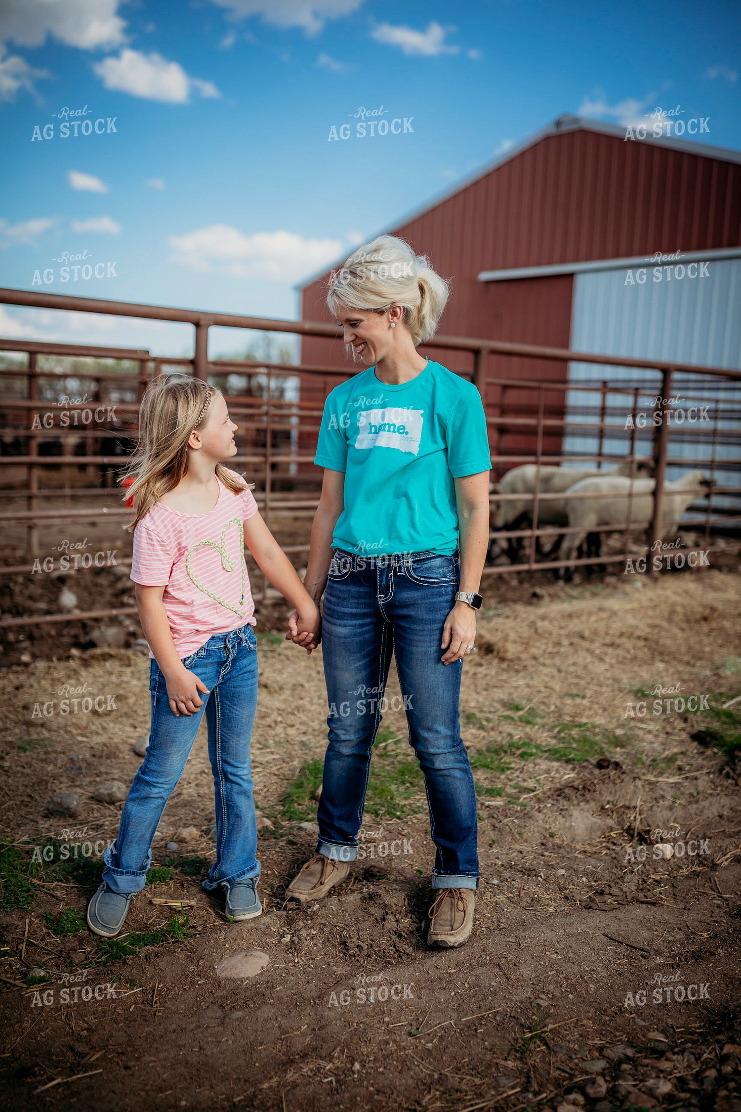 Female Rancher and Daughter Checking Cattle 285030