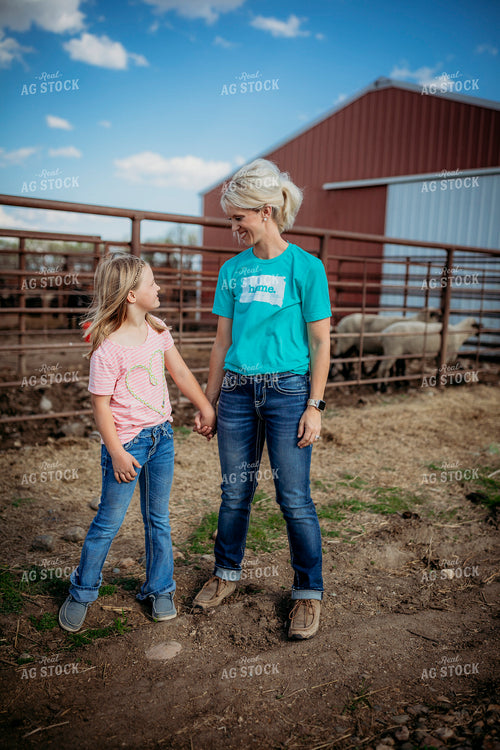 Female Rancher and Daughter Checking Cattle 285030