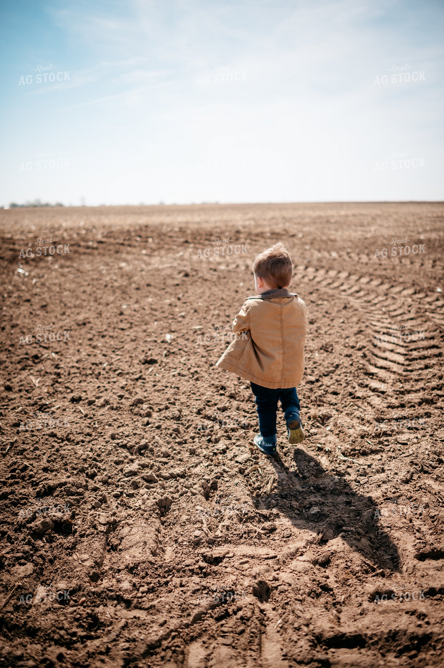 Farm Kid Walks in Freshly Planted Field 56637
