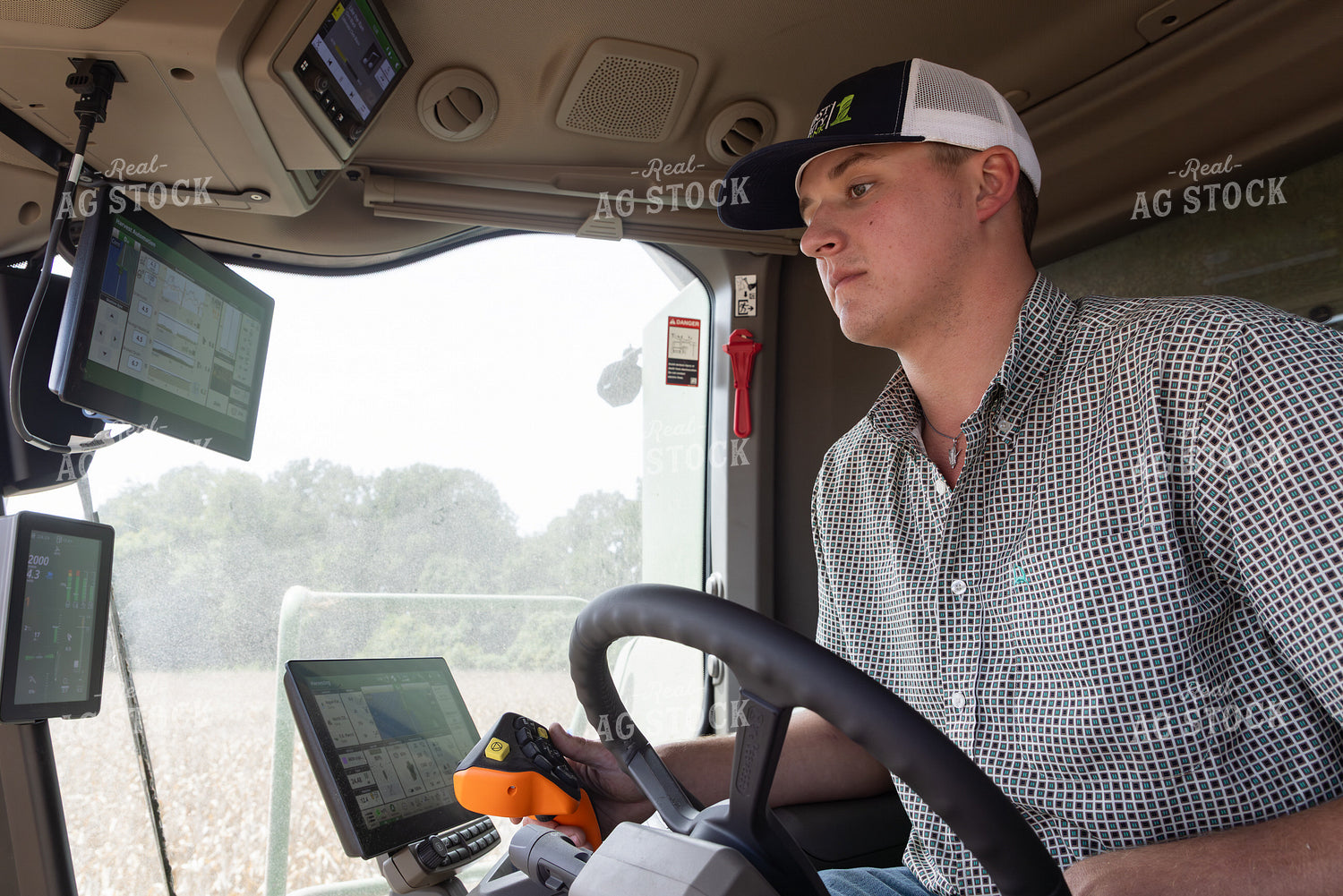 Young Farmer in Combine Cab 79830