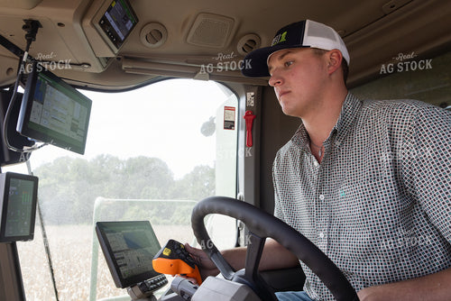 Young Farmer in Combine Cab 79830