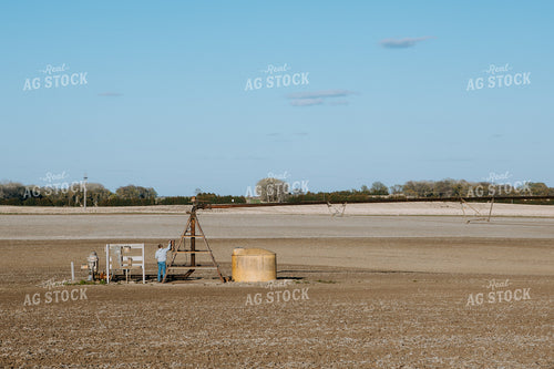 Farmer Working on Irrigation Control Panel 77247