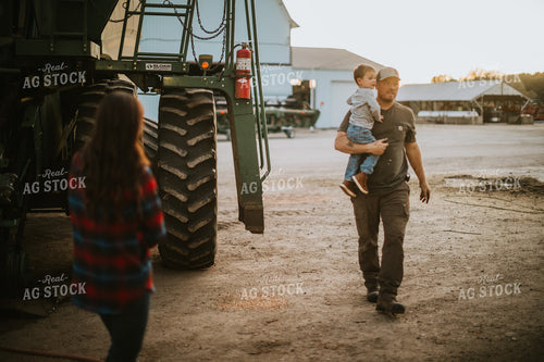 Farmer Working on Combine with Farm Kid 5132