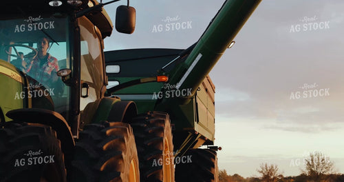 Female Farmer Getting Out of Auger Wagon with Combine Cutting Beans in Background 3966
