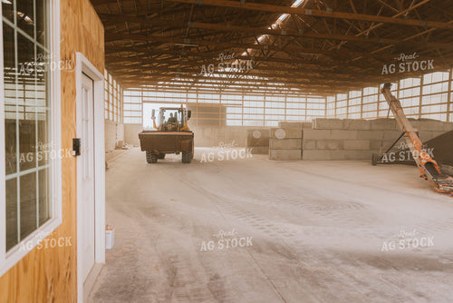 Tractor Loads Dry Feed in Storage Shed 7520
