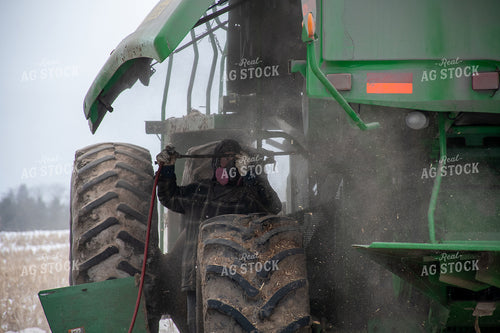Farmer Cleaning Combine 50461