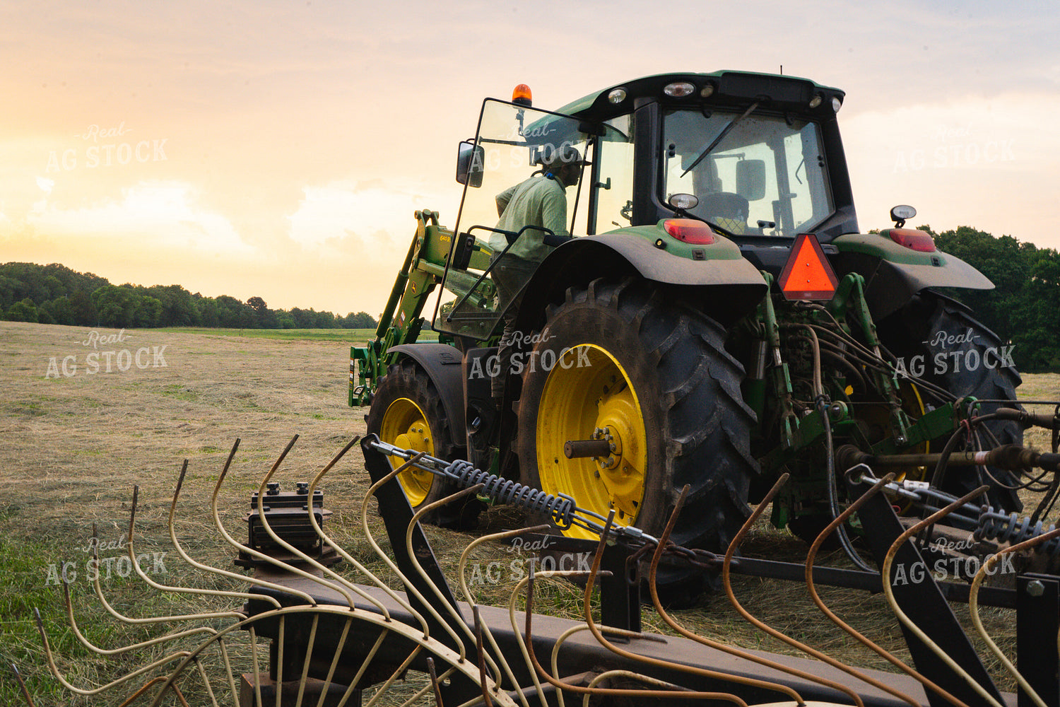 Farmer Climbs into Tractor Cab Preparing to Bale Hay 128029