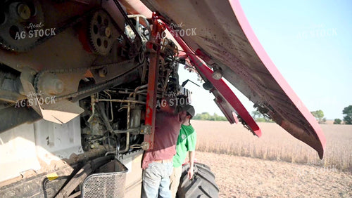 Multigenerational Farm Familiy Repairing Combine in a Bean Field - 427