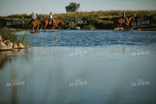 Ranchers on Horses in Creek 6386