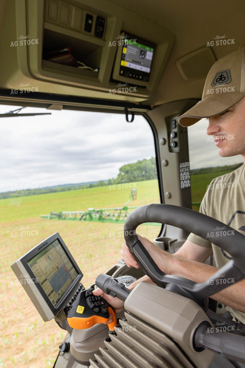 Farmer Driving Sprayer with Equipment Monitor Visible 79297