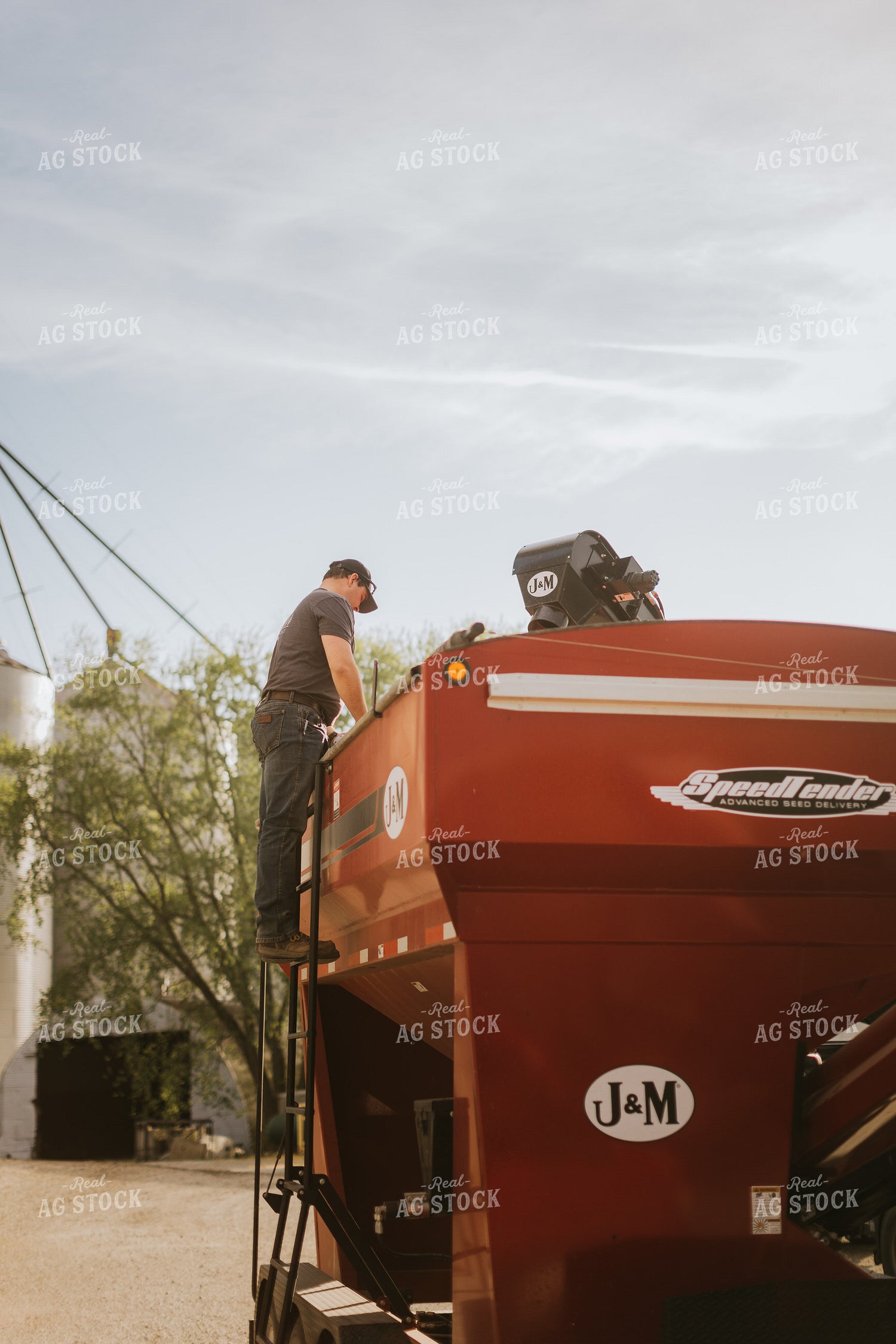 Farmer Looks into Seed Tender Hopper 7604