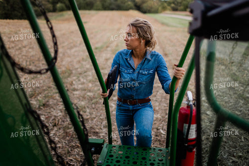 Female Farmer Climbing into Combine 8393