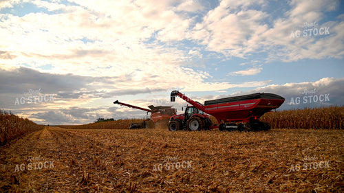 Combine Unloading Corn into Auger Wagon on the Go 25639