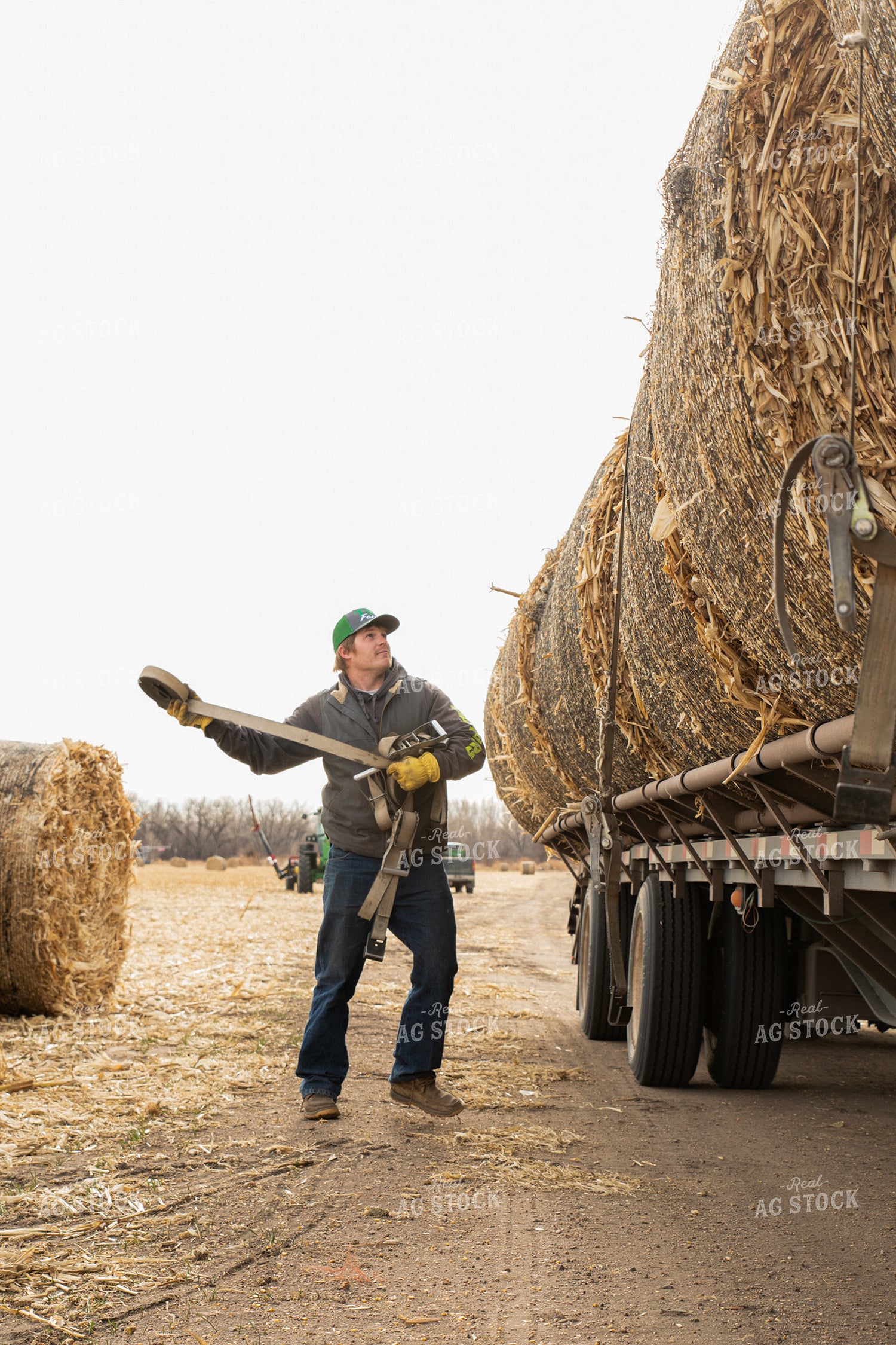 Farmer Secures Bales on Trailer 223011