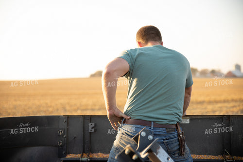 Farmer Fixing Combine 286040