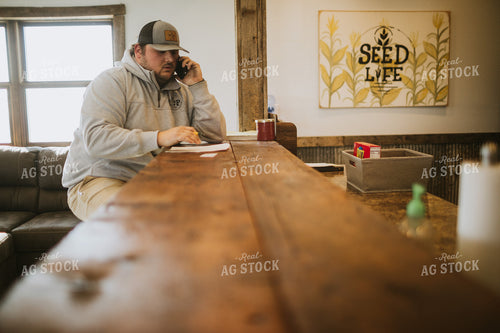 Man Going Over Paperwork and Talking on Phone 5300