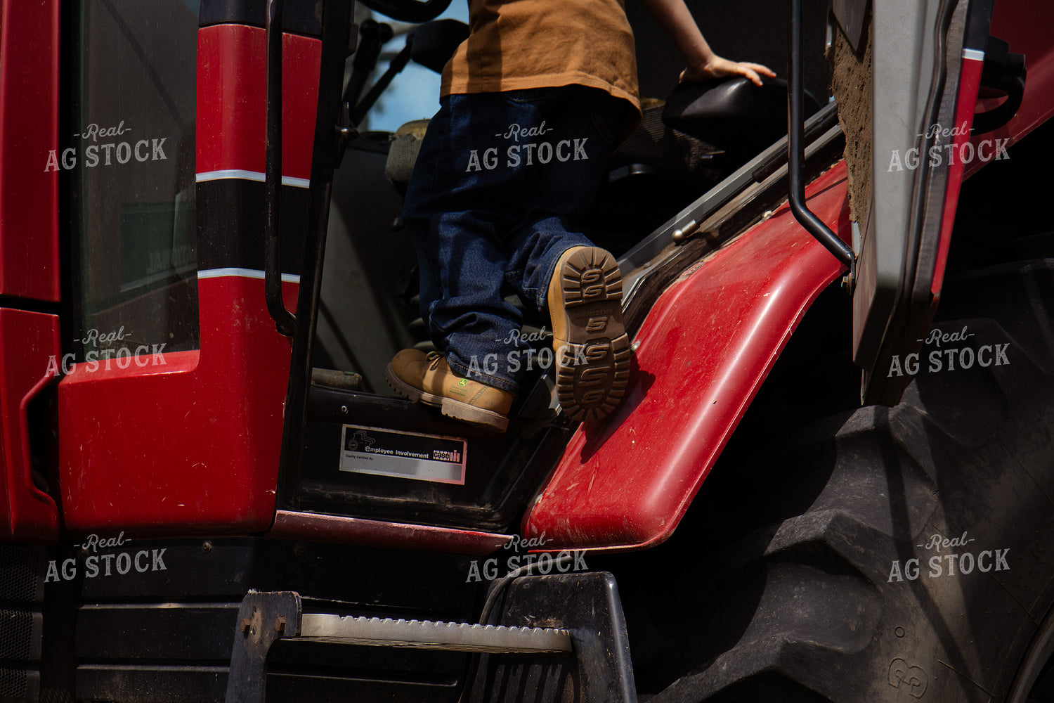 Farm Kid Climbing Into Tractor 268299