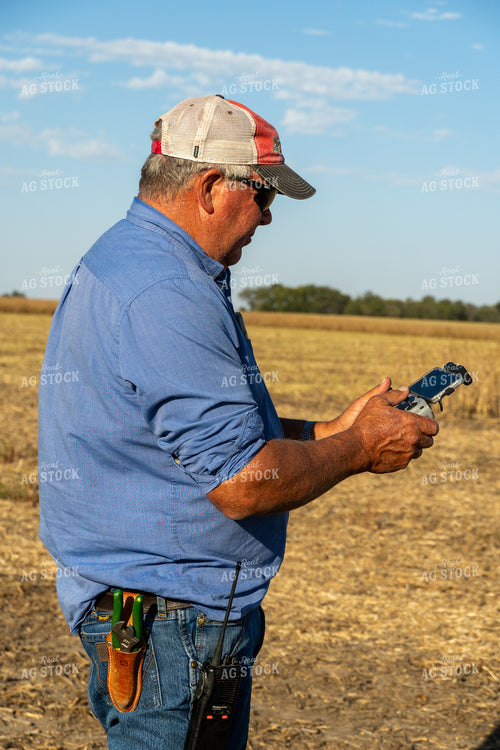 Farmer Flying Drone in Field 65086