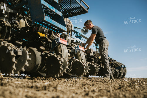 Farmer Adjusting Planter 4130