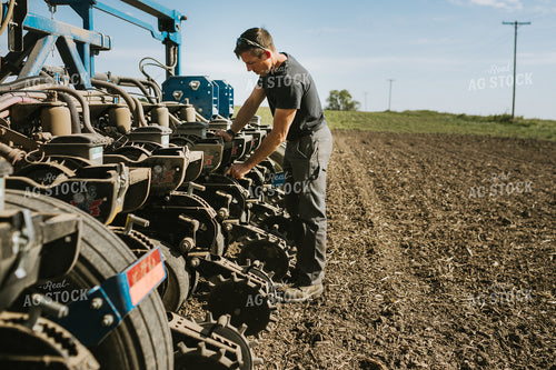 Farmer Adjusting Planter 4129