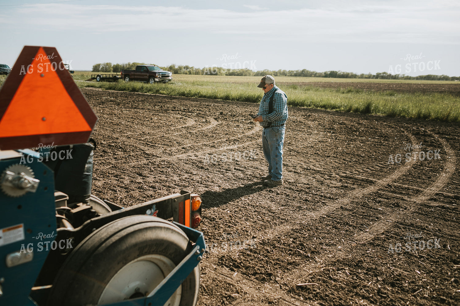 Farmer Looking at Phone in Field 4123