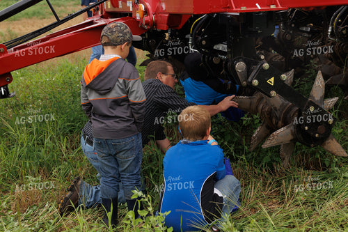 Farmer and Farm Kids Working on Equipment 295075