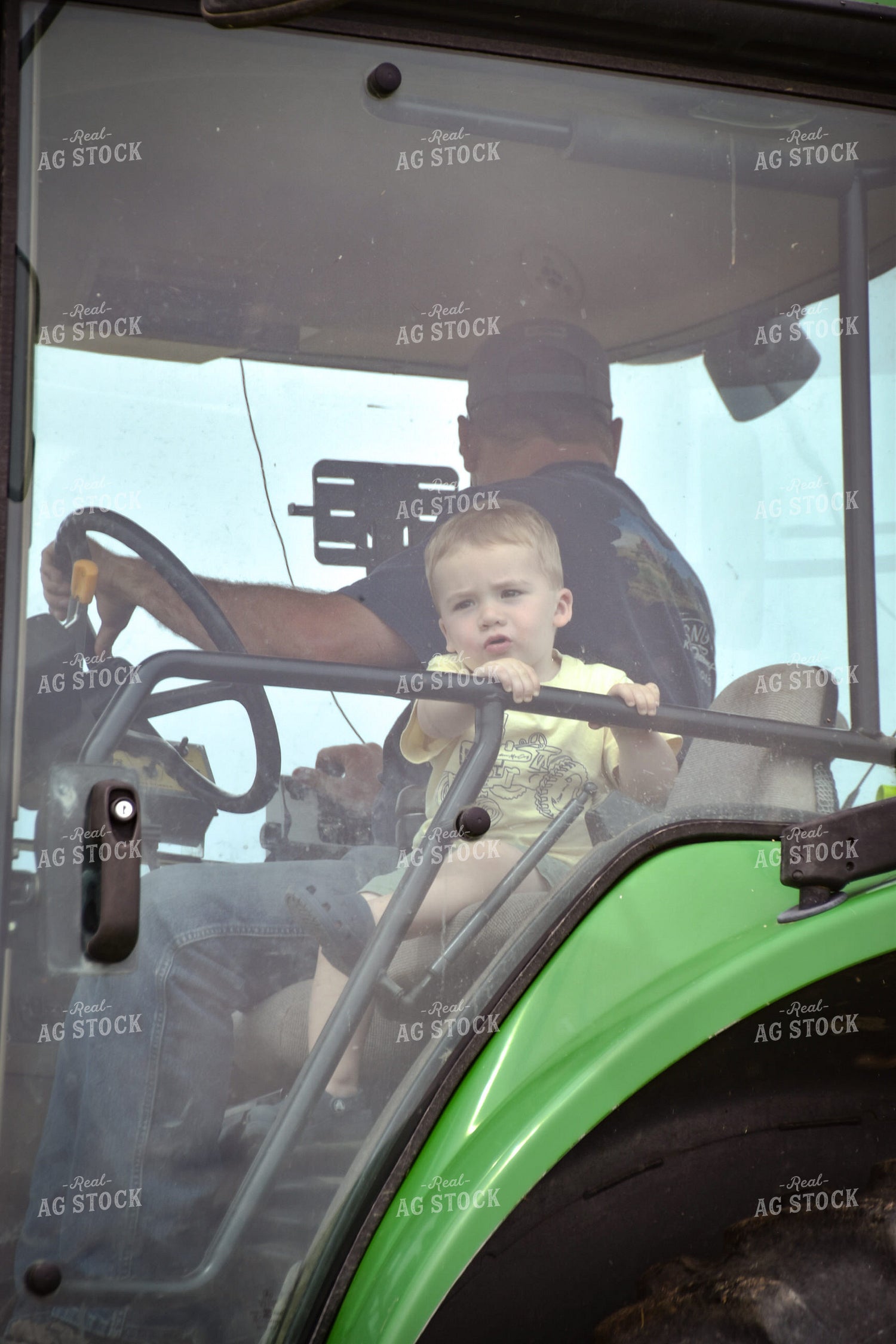 Farmer and Little Boy in Tractor Cab 56429