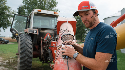 Farmer Operating Sweep Auger 26262