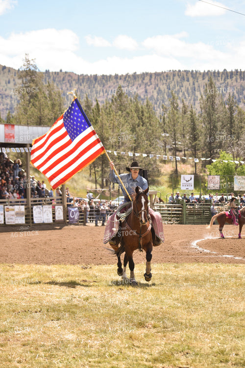 Rancher Carrying American Flag on Horseback 263001