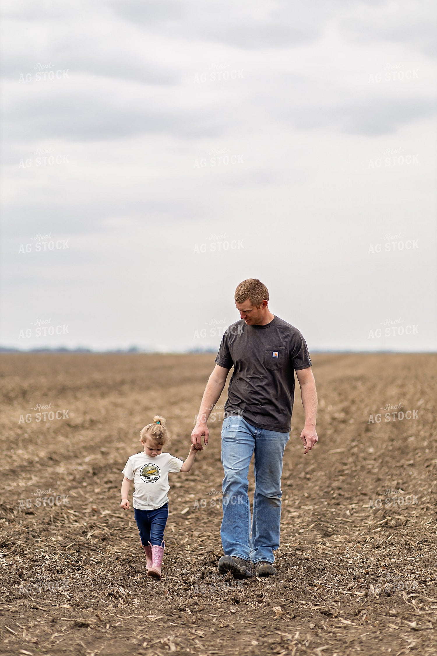 Farmer and Daughter Walking in Field 93314