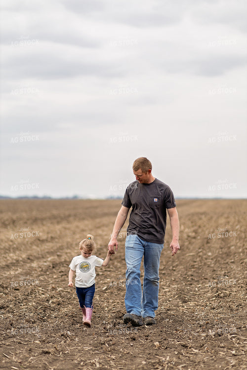 Farmer and Daughter Walking in Field 93314