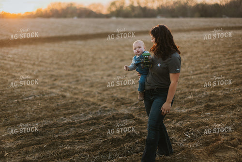 Farmer Holding Farm Kid in Field 7460