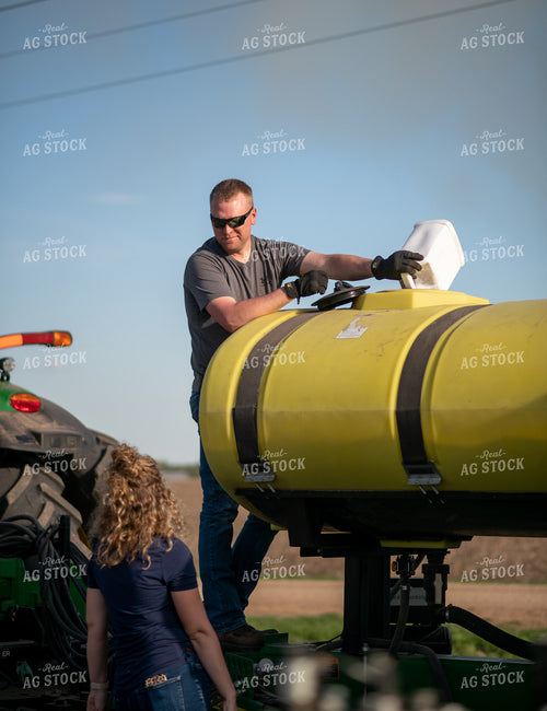 Farmer Filling Planter with Starter 76369
