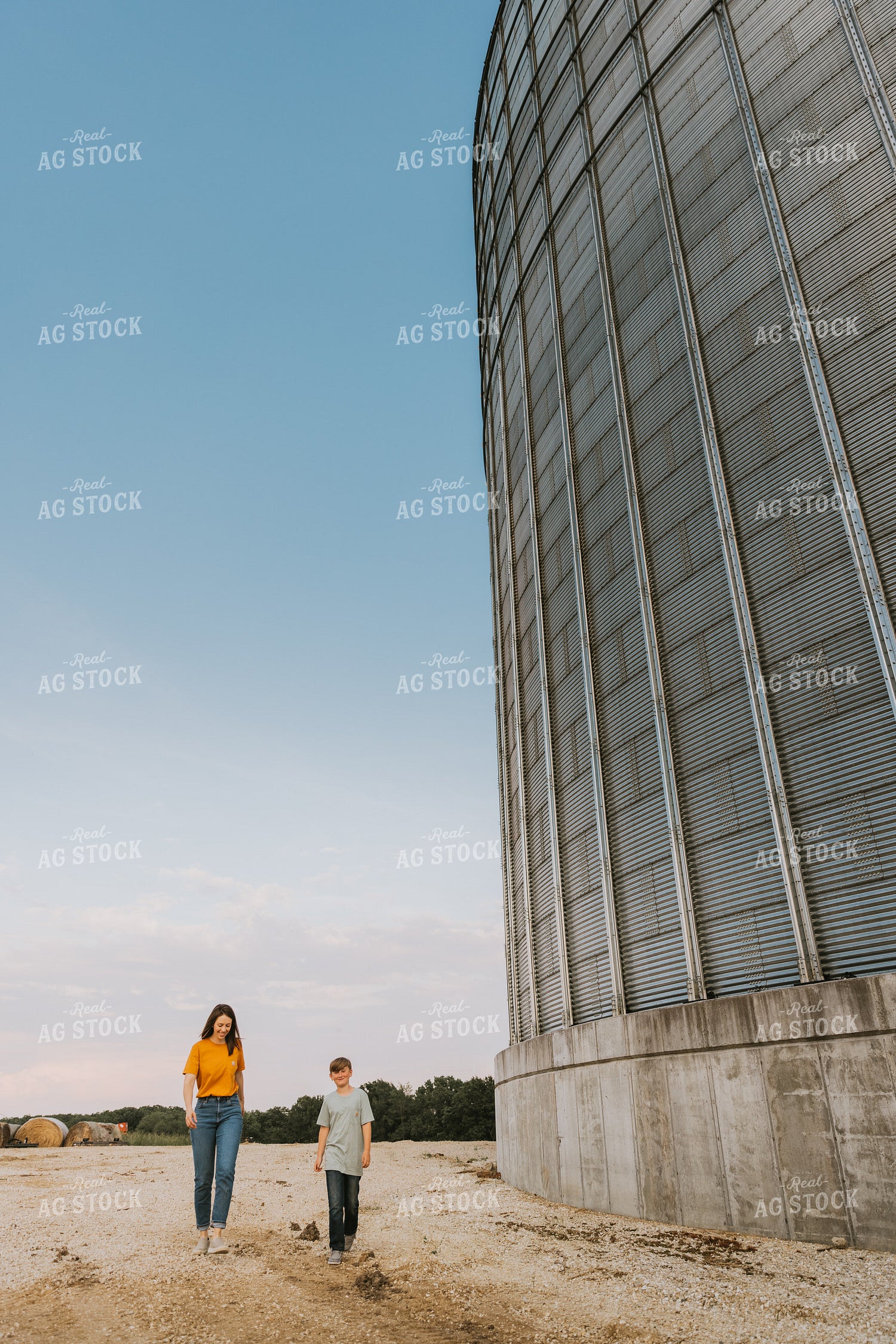 Farm Wife and Son Walk by Grain Bin 7803