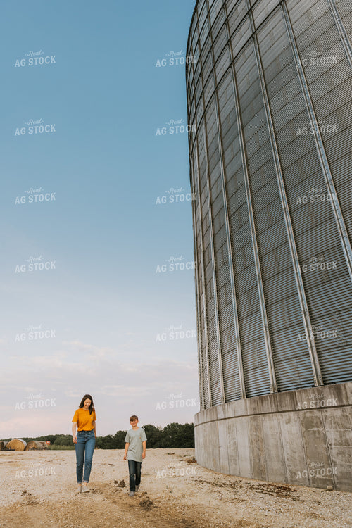 Farm Wife and Son Walk by Grain Bin 7803