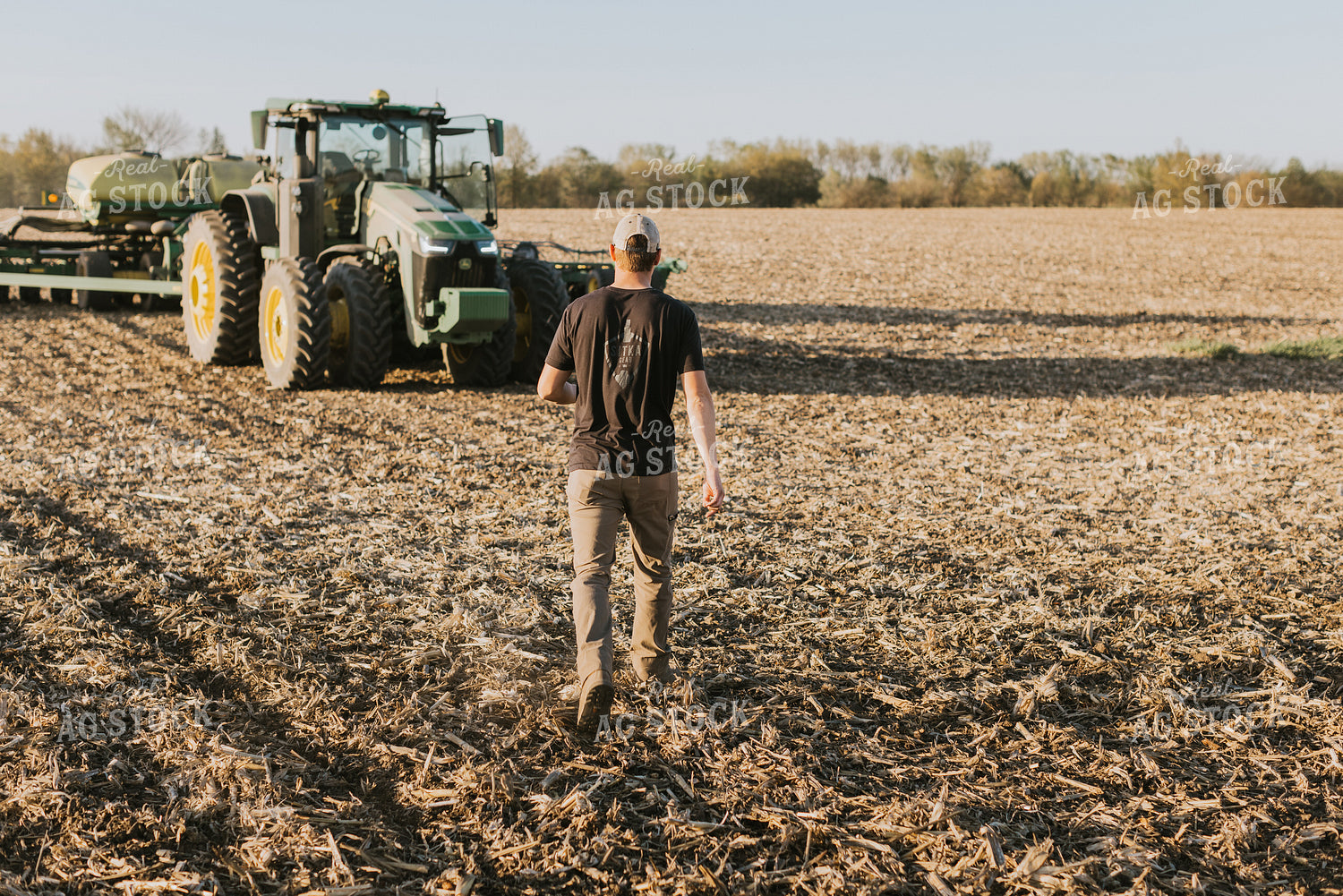 Young Farmer Walks Toward Tractor 7678